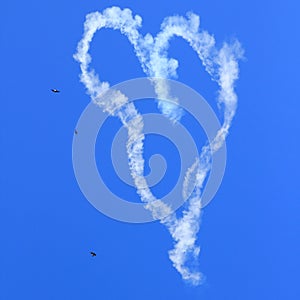 Heart skywriting with birds in sky