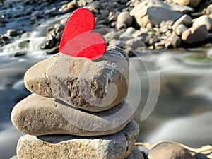 Heart on stacked rocks background. Stock photo.