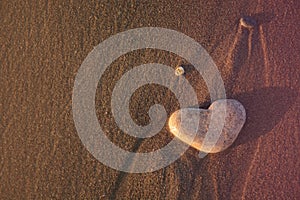 Heart of stone on the pebble beach. Love concept. Valentines background