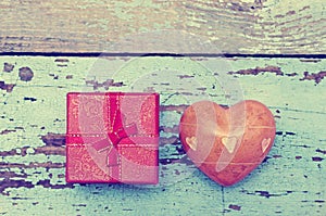 Heart with stones and small gift box with a bow