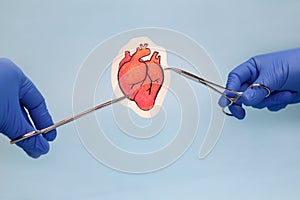 Heart surgery. Medical instruments and drawing of heart on blue background.