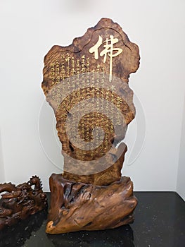 Carved wooden ornament with Buddhist sutra on it. The Prajna Paramita Hrdaya Sutra. photo