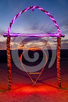 Heart swing with lights in the desert