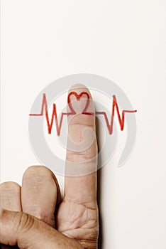 Heart symbol in the forefinger of a man photo