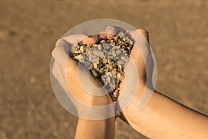 Heart symbol with hands and stones