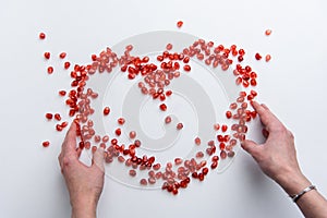 Heart symbol made from pomegranate seeds isolated