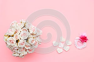 Heart symbol made of stone, white pink roses. Valentine`s and mothers day background. Flat lay, top view