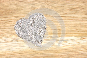 Heart symbol made of white chia seeds