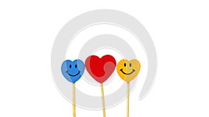 Heart between two smile faces in middle of white background