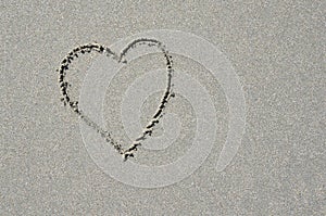 Heart in white tropical sand.