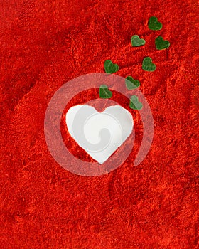 Heart white on a vibrant red soft dusty background with small green hearts coming out of it. Valentine love aesthetic design