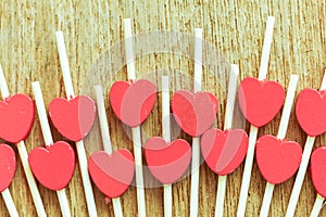 Valentines day concept. Couple of red glitter hearts on wooden b photo