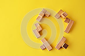 The heart of the wooden elements of the logical puzzle on a yellow background view from above with a copy space. I like