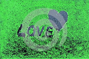 The heart and the word love concept. on a green background