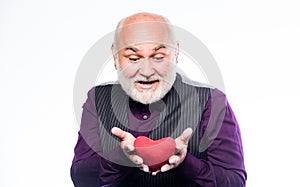 Heartbeat diagnostics and treatment. Health care. Preventing heart attack. Senior bald head bearded man holding red toy