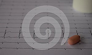 Heartbeat represented on paper. Electrocardiogram with selective focus. Representation of cardiac arrhythmias