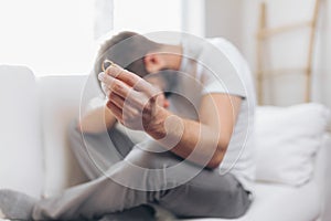 Heartbroken man holding a wedding ring