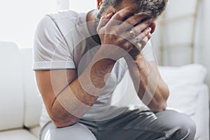 Heartbroken man holding a wedding ring