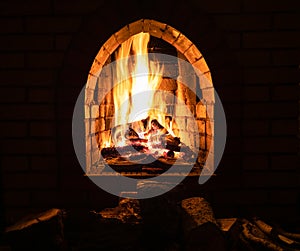 Hearth with burning firewood at night