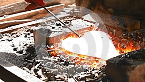 In the hearth are forged components for metallic flower