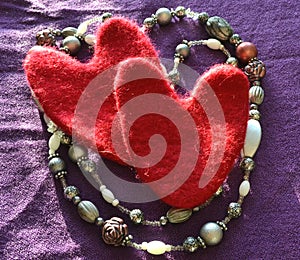 Hearts and beads on a purple cloth