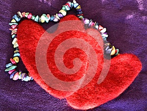 Hearts and beads on a purple cloth