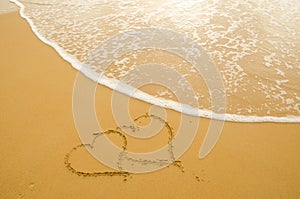 Hearts drawn on the sand beach