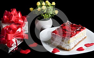 Hearts  gift boxes  flowers and cake with red berries on white plate Isolated on black background. Holiday food Valentines day