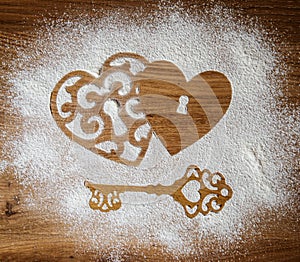Hearts and a key of the flour as a symbol of love on wooden background. Valentines day background. Vintage retro card.