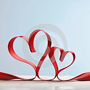 Hearts made from red ribbon. Valentine's card