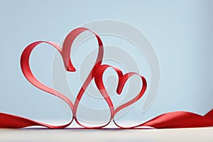 Hearts made from red ribbon. Valentine& x27;s card