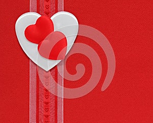 Hearts and ribbon on a red background