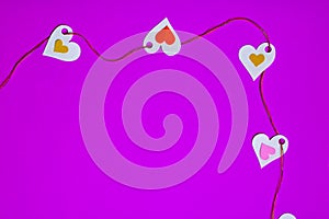 Hearts in a row, the top-left corner, on a violet background