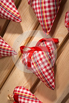 hearts sewn from red plaid fabric on the board,