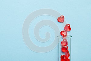Hearts and test tube. Baby from tube vitro glass. Artificial insemination, IVF. Blue background. Copy space for text. photo
