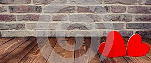 Hearts on wooden floor with bricks background for Valentines day. Symbols of love for Happy Women`s, Mother`s, Valentine`s Day,