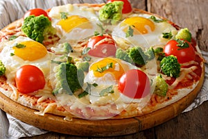 Hearty breakfast of pizza with eggs, broccoli, tomatoes closeup