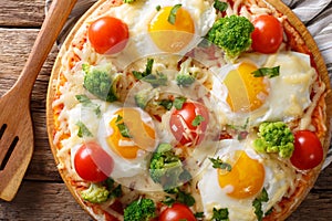 Hearty breakfast of pizza with eggs, broccoli, tomatoes closeup