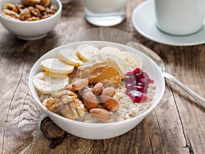 A hearty and healthy oatmeal Breakfast with walnuts, almonds and