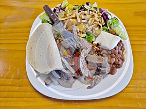 Hearty Mexican Fajita Plate with Beans, Salad, and Tortilla