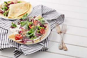 Hearty pancakes with fresh salad, tomato and radicchio