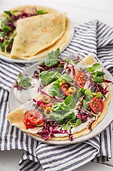 Hearty pancakes with fresh salad, tomato and radicchio