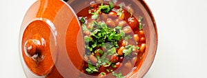 A hearty serving of baked beans in a ceramic dish, a healthy and nutritious meal