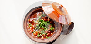 A hearty serving of baked beans in a ceramic dish, a healthy and nutritious meal