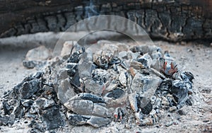 Heat from burnt wood logs in the fireplace on a picnic.