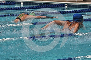 A heat of butterfly swimmers racing at a swim meet photo