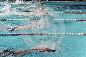 A heat of freestyle swimmers racing at a swim meet photo