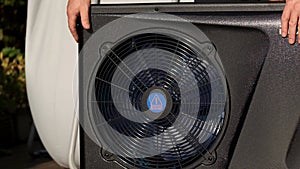 Heat pump.Device for heating water and air. Alternative energy.Black heat pump with spinning fan.Pool heating