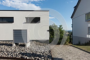 heat pump in a new building area with modern house facades