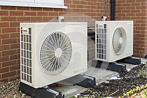 Heat pumps installed on the outside of a modern house photo